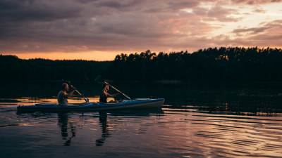 Two people kayaking at sunset