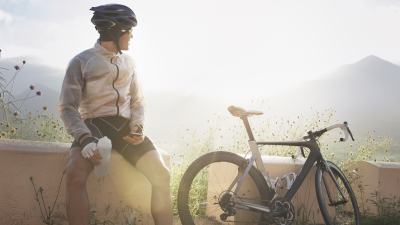 Cyclist resting beside bicycle in the mountains