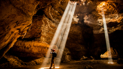 Person taking photographs in a cave